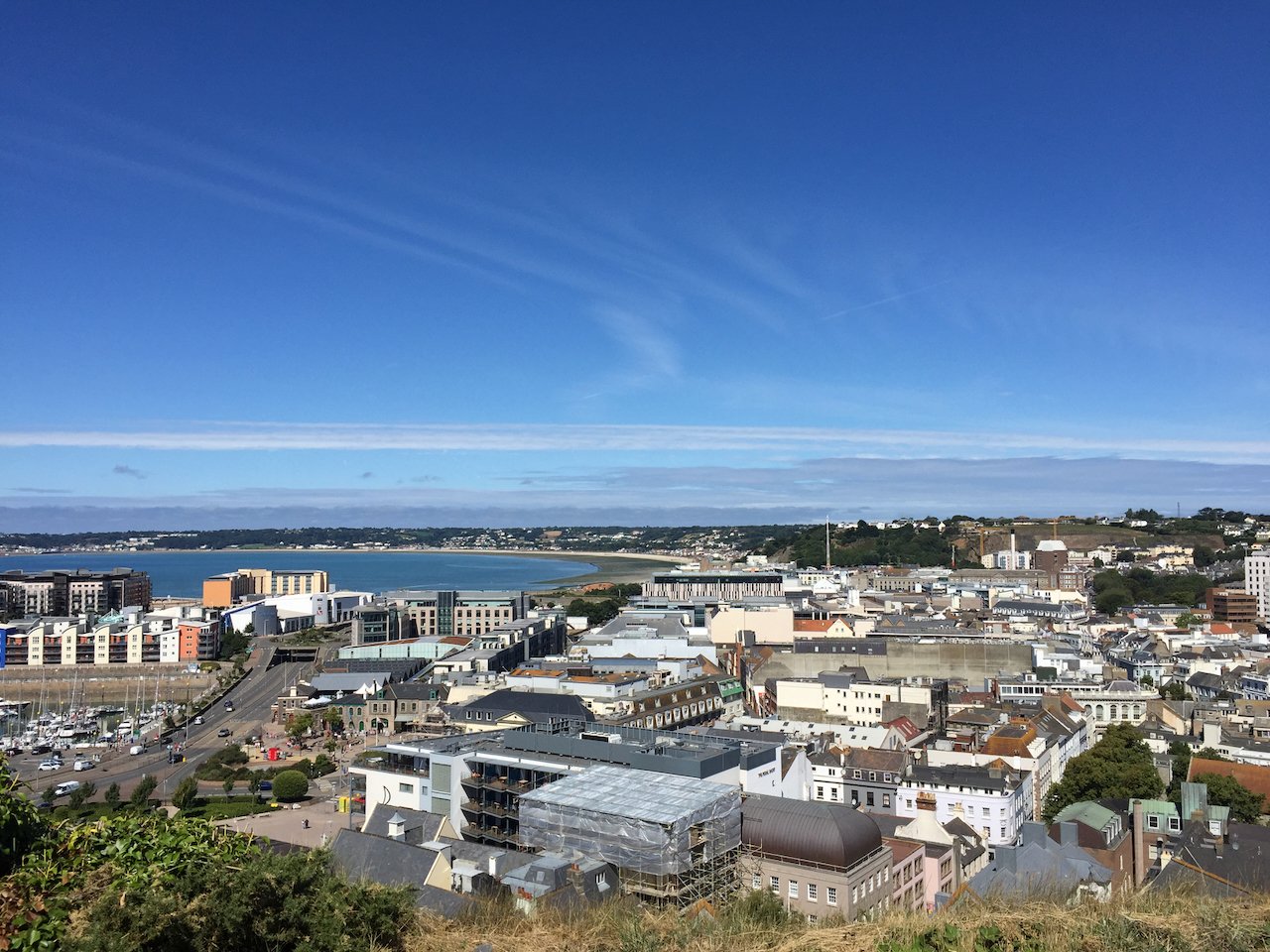 St Helier, Jersey. Photographed from Fort Regent, facing West, in the afternoon summer sun, with blue skies and a variety of buildings in the skyline.
