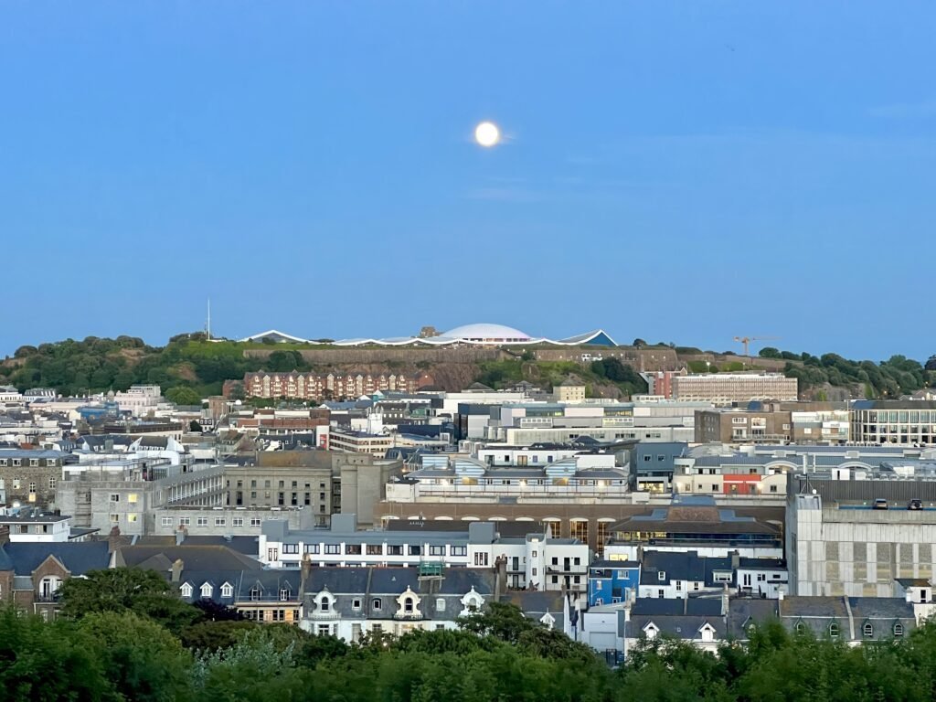 Public Services & Press 📰 1 st helier jersey town skyline east to west full moon